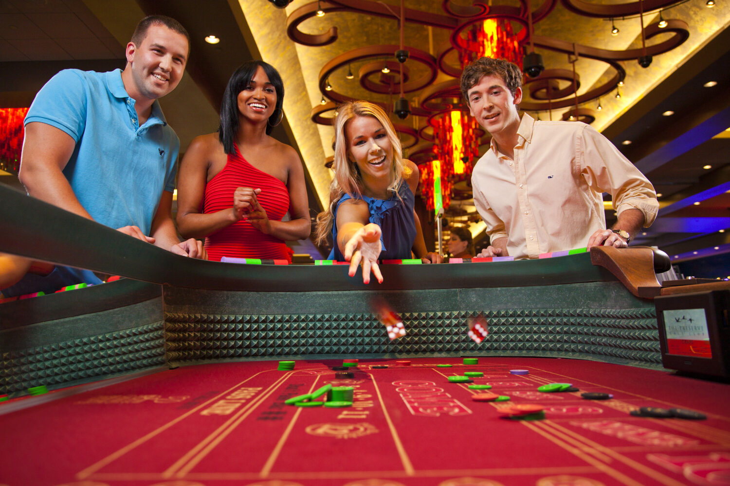 Happy Group Of Adults Gambling At Craps Table Stock Photo